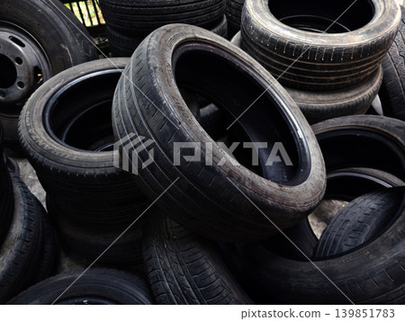 Outdoor storage area with aged tires emphasizing recycling and reuse opportunities 139851783