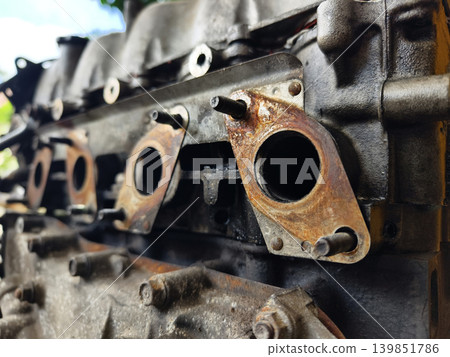 Rusted engine parts and corroded gears scattered across the sandy ground Rusted engine parts and corroded gears scattered across the sandy ground 139851786