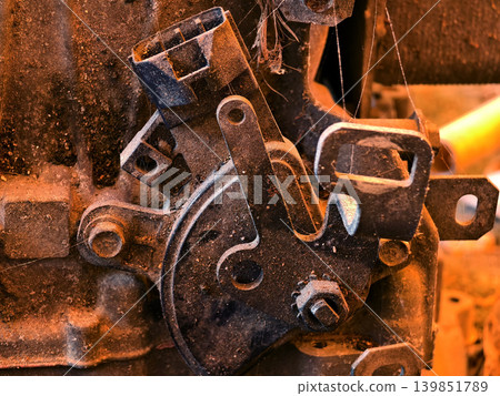 Rusted engine parts and corroded gears scattered across the sandy ground Rusted engine parts and corroded gears scattered across the sandy ground 139851789