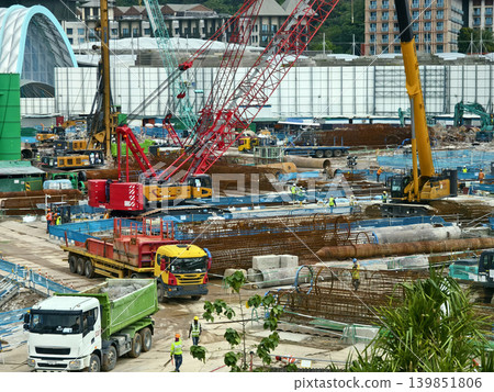 Active construction team erects building with tools and supports Active construction team erects building with tools and supports 139851806