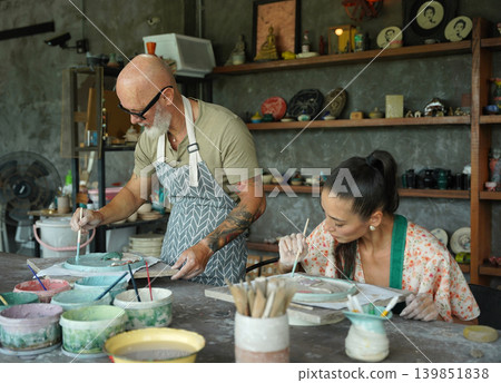 A happy couple makes ceramic plates in a workshop A happy couple makes ceramic plates in a workshop 139851838