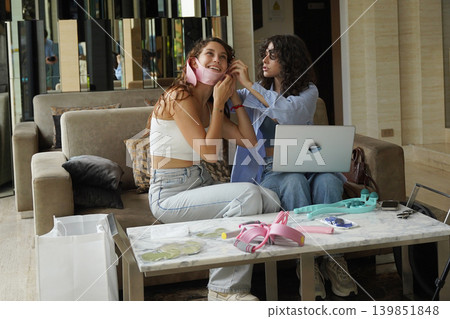 Two young women run a blog and sell massagers through a website Two young women run a blog and sell massagers through a website 139851848