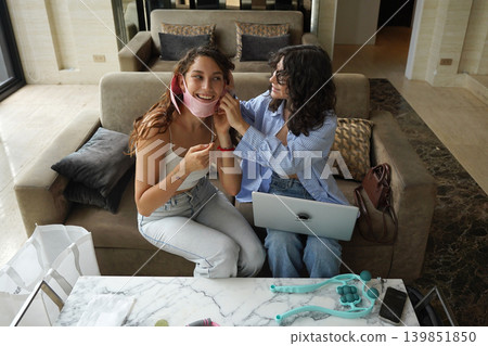 Two young women run a blog and sell massagers through a website Two young women run a blog and sell massagers through a website 139851850