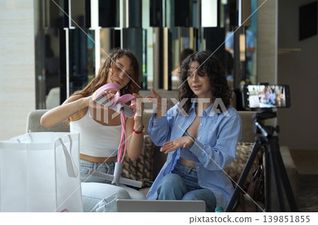 Two young women run a blog and sell massagers through a website Two young women run a blog and sell massagers through a website 139851855