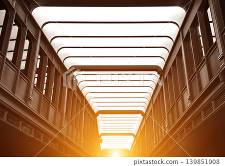 Luminous steel corridor featuring arched structures and dramatic harmony in urban setting Luminous steel corridor featuring arched structures and dramatic harmony in urban setting 139851908