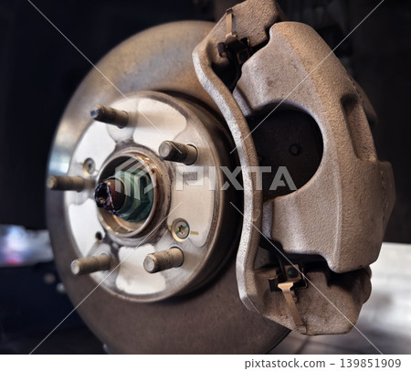 Pile of rusted motor components and gears in cluttered scrap heap 139851909