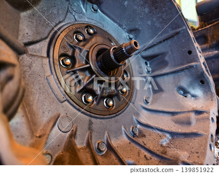 Rusted engine parts and corroded gears scattered across the sandy ground Rusted engine parts and corroded gears scattered across the sandy ground 139851922