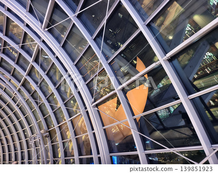 Glass canopy showcasing repeating geometric frames and day light Glass canopy showcasing repeating geometric frames and day light 139851923