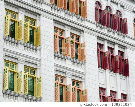 Historic building facade showcasing colorful shutters and intricate architectural elements 139851924