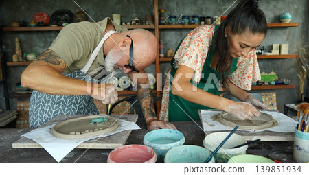 A happy couple makes ceramic plates in a workshop A happy couple makes ceramic plates in a workshop 139851934