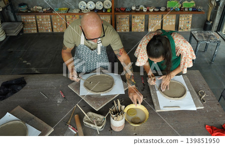 A happy couple makes ceramic plates in a workshop A happy couple makes ceramic plates in a workshop 139851950