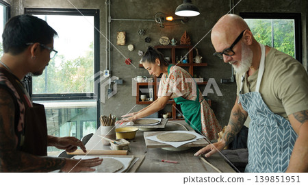 A happy couple makes ceramic plates in a workshop A happy couple makes ceramic plates in a workshop 139851951