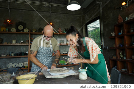 A happy couple makes ceramic plates in a workshop A happy couple makes ceramic plates in a workshop 139851960