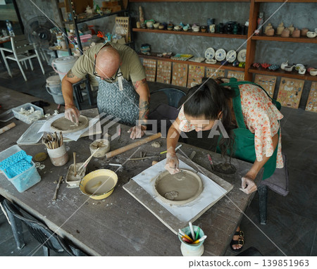 A happy couple makes ceramic plates in a workshop A happy couple makes ceramic plates in a workshop 139851963