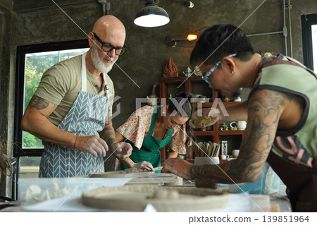 A happy couple makes ceramic plates in a workshop A happy couple makes ceramic plates in a workshop 139851964