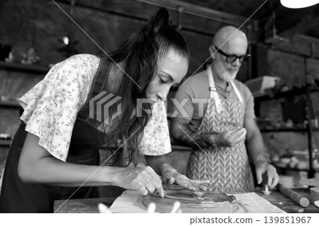 A happy couple makes ceramic plates in a workshop A happy couple makes ceramic plates in a workshop 139851967