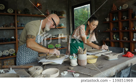 A happy couple makes ceramic plates in a workshop A happy couple makes ceramic plates in a workshop 139851969