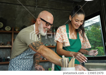 A happy couple makes ceramic plates in a workshop A happy couple makes ceramic plates in a workshop 139851970