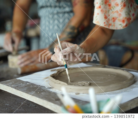 A happy couple makes ceramic plates in a workshop A happy couple makes ceramic plates in a workshop 139851972
