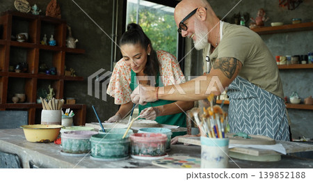 A happy couple makes ceramic plates in a workshop A happy couple makes ceramic plates in a workshop 139852188