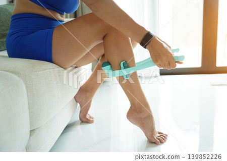 Calf recovery using handheld teal massage roller device 139852226