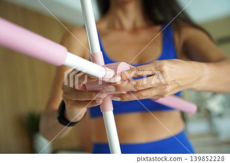 Woman blue sportswear adjusting physiotherapy device to correct his posture Woman blue sportswear adjusting physiotherapy device to correct his posture 139852228