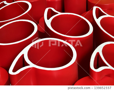 red paper rolls tightly arranged forming layered spiral shapes with white inner edges 139852337