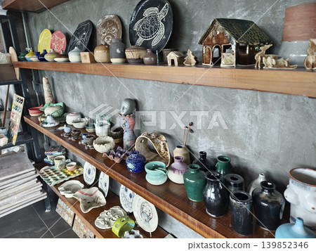 Inviting workshop and social spot showcasing handcrafted pottery amidst warm rustic decor 139852346