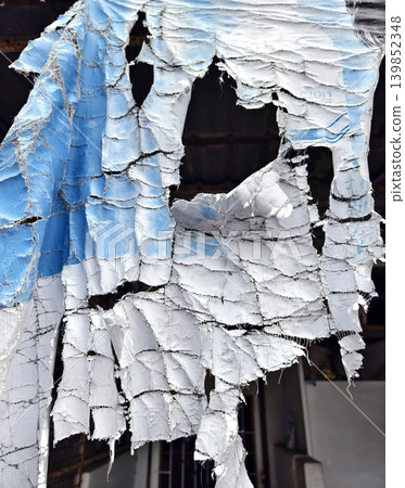 Faded banner above neglected urban shopfront Faded banner above neglected urban shopfront 139852348