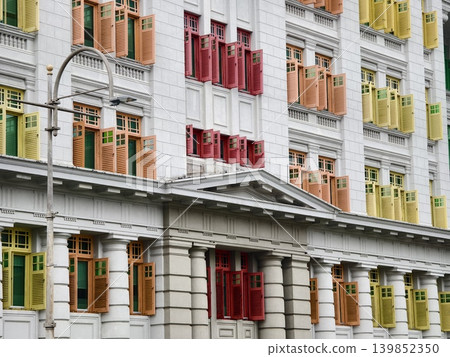 Historic building facade showcasing colorful shutters and intricate architectural elements 139852350
