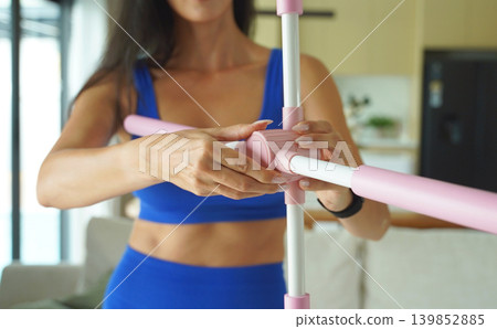 Woman blue sportswear adjusting physiotherapy device to correct his posture Woman blue sportswear adjusting physiotherapy device to correct his posture 139852885