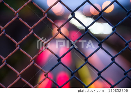Fence and car lights creating bokeh effect Fence and car lights creating bokeh effect 139852896