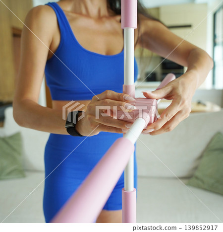 Woman blue sportswear adjusting physiotherapy device to correct his posture Woman blue sportswear adjusting physiotherapy device to correct his posture 139852917