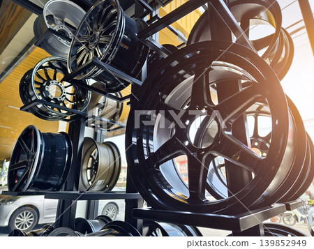 Luxurious automotive display featuring chrome wheels and warm lighting 139852949