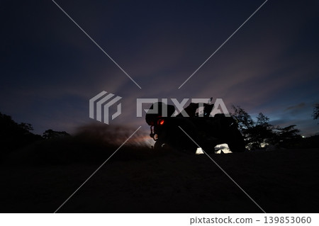 A man engages in extreme ATV riding on mountains in the evening 139853060