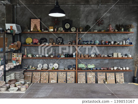 Inviting workshop and social spot showcasing handcrafted pottery amidst warm rustic decor Inviting workshop and social spot showcasing handcrafted pottery amidst warm rustic decor 139853167