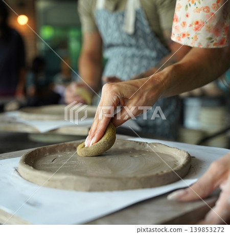 A happy couple makes ceramic plates in a workshop A happy couple makes ceramic plates in a workshop 139853272