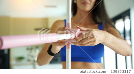 Woman blue sportswear adjusting physiotherapy device to correct his posture Woman blue sportswear adjusting physiotherapy device to correct his posture 139853317