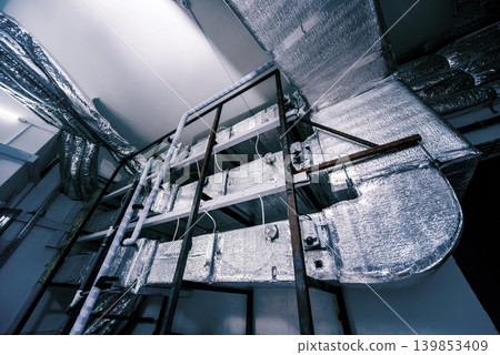Ventilation pipe system indoors. Modern Industrial background. Ventilation pipe system indoors. Modern Industrial background. 139853409