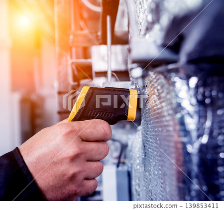 Technician use infrared thermal imaging camera to check temperature at fuse-box Technician use infrared thermal imaging camera to check temperature at fuse-box 139853411