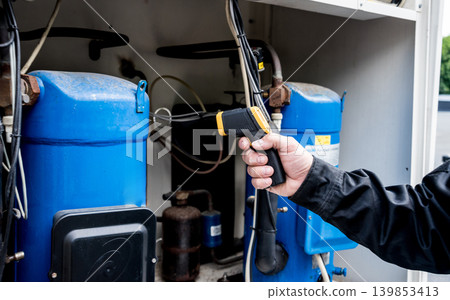 Technician use infrared thermal imaging camera to check temperature at fuse-box Technician use infrared thermal imaging camera to check temperature at fuse-box 139853413