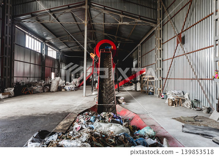At modern recycling plant. Conveyor belt for transports garbage At modern recycling plant. Conveyor belt for transports garbage 139853518