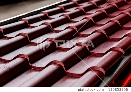 Red metallic roof tiles background with drops of water. 139853596