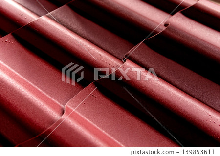 Red metallic roof tiles background with drops of water. 139853611