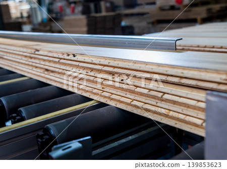 Production line of the wooden floor factory. CNC automatic woodworking machine. 139853623