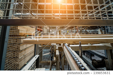 Production line of the wooden floor factory. CNC automatic woodworking machine. Production line of the wooden floor factory. CNC automatic woodworking machine. 139853631