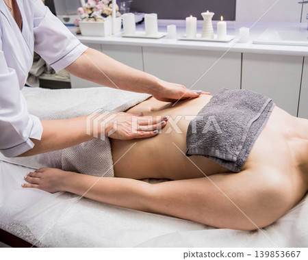 Beautiful young woman enjoying massage in spa salon. Cosmetology Beautiful young woman enjoying massage in spa salon. Cosmetology 139853667