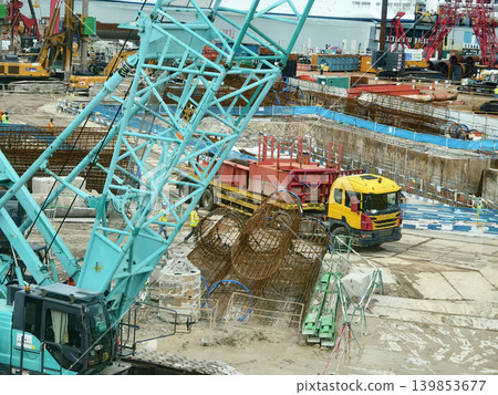 Active construction team erects building with tools and supports Active construction team erects building with tools and supports 139853677