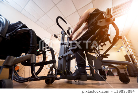 Disabled man training in the gym. Rehabilitation center Disabled man training in the gym. Rehabilitation center 139853894