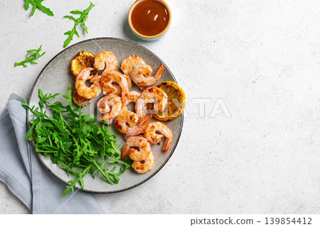 Grilled shrimps, prawns with arugula Grilled shrimps, prawns with arugula 139854412